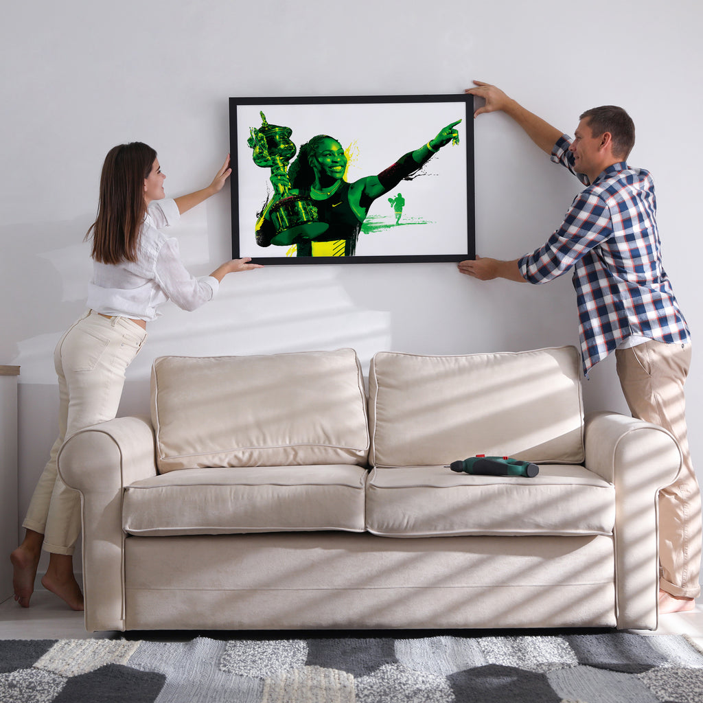 "Serena Williams illustrated poster being hung on wall — tennis gift for her"