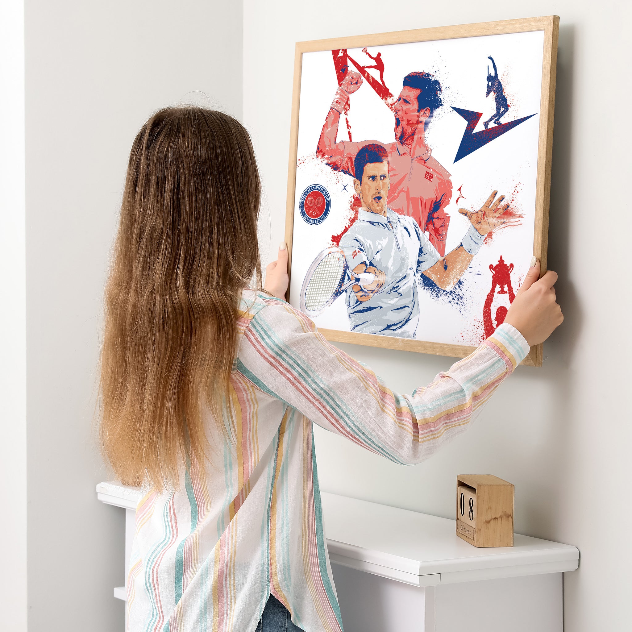 "Woman hanging Djokovic illustrated poster on wall — tennis gift for him"